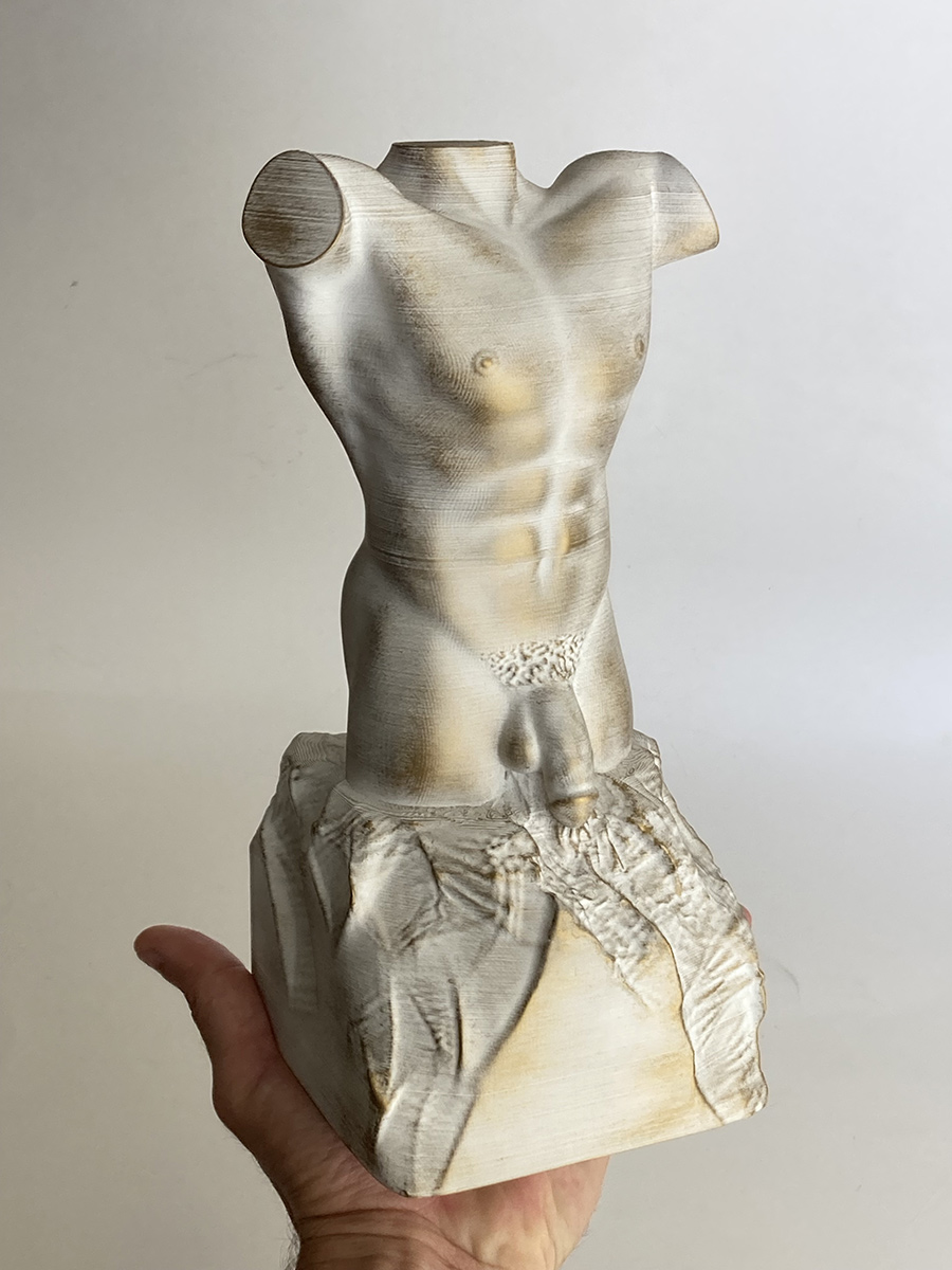 male torso sculpture white antique finish held in hand showing scale